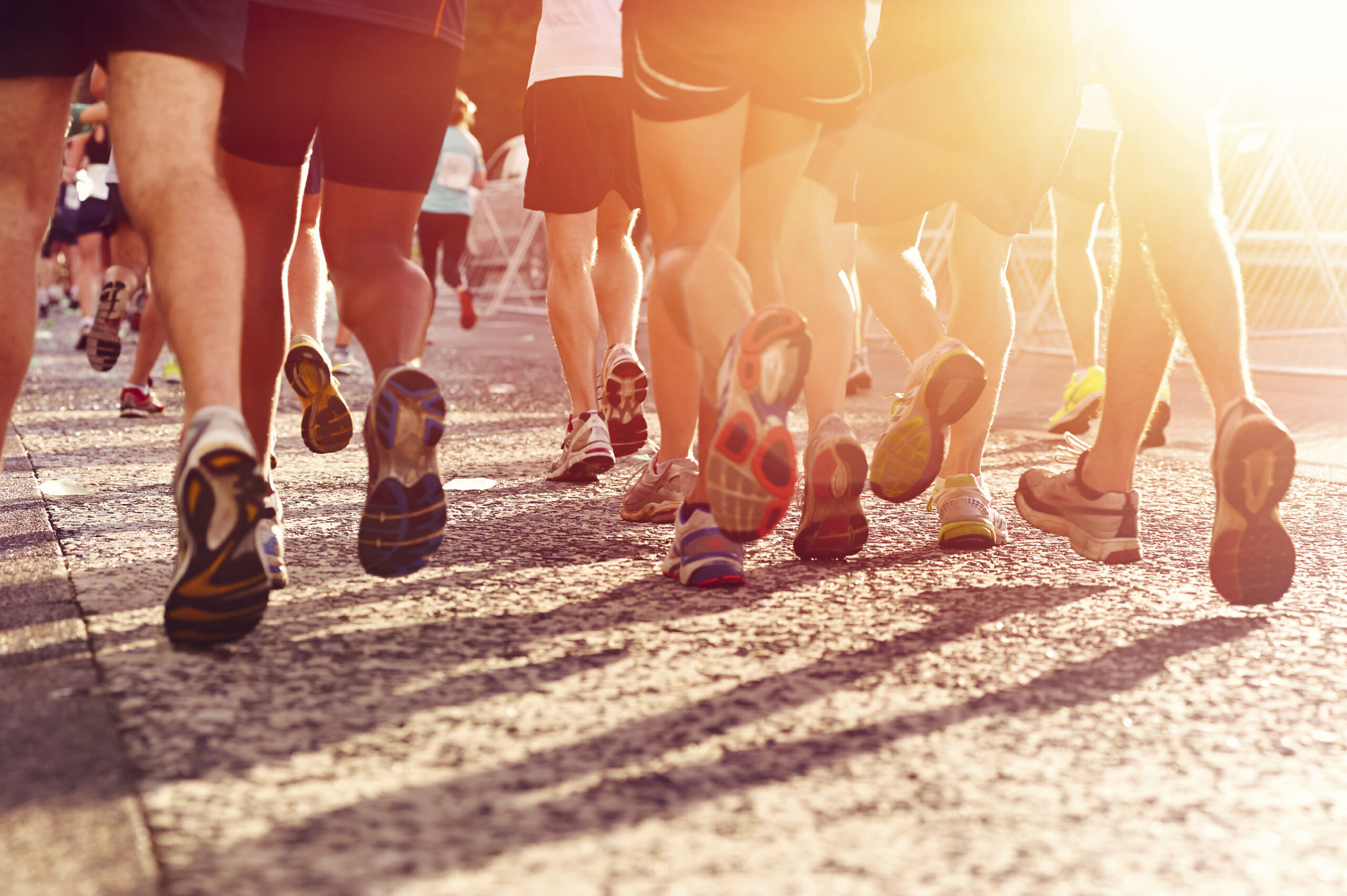 Marathon running race people competing in fitness and healthy active lifestyle feet on road